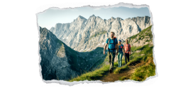 Bild zeigt 3 Bergwanderer auf einem Bergpfad mit den Bergen im Hintergrund