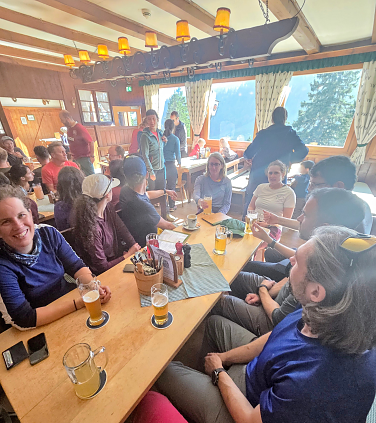 IMG group celebrating in a hut